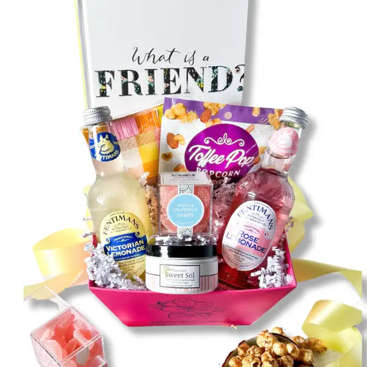 BFF Basket featuring a pink baskets and fruity self care snacks with a book " what is a friend" Apple Blossom Gift Baskets seattle gift baskets