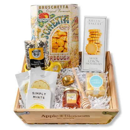 A Drop of Joy gift basket with tea, cookies, mug and snacks featuring products made in Seattle, Washington Apple Blossom Gift Baskets