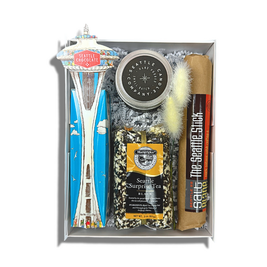 the seattle gift box features a space needle truffle gift box, seattle sprprise loose tea, seattle candle company coffee candle and the seattle stick salami